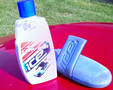 1993 Ford Probe - ICE car wash soap and applicator pad are placed on the hood of a red vehicle.