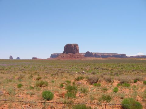 1997 Ford Ranger - Monument Valley landscape with iconic rock formations and sparse vegetation under a bright blue sky.