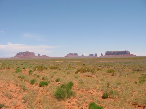 1997 Ford Ranger - A wide desert vista with iconic mesas and scrub brush under a bright blue sky, a Supermotors.net watermark.
