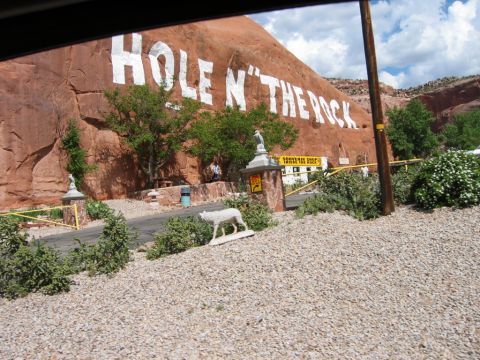 1997 Ford Ranger - The Hole N' The Rock attraction features large white lettering painted on a red rock cliff face, with a souvenir shop and a wolf statue vis…