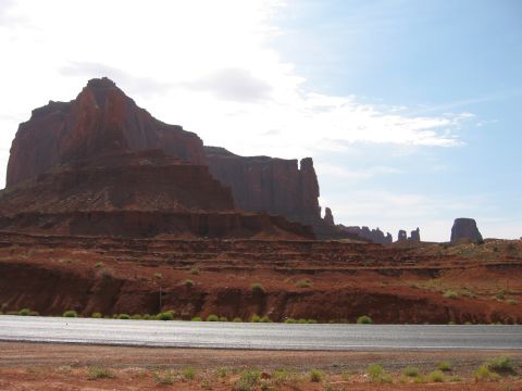 1997 Ford Ranger - Scenic view of Monument Valley's iconic red rock formations under a partly cloudy sky.