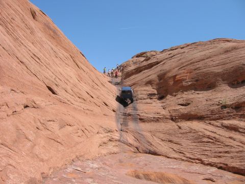 1997 Ford Ranger - A vehicle carefully descends a challenging rocky trail in a desert landscape.