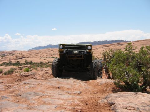 1997 Ford Ranger - Two off-road vehicles navigate a rocky desert landscape under a clear blue sky.