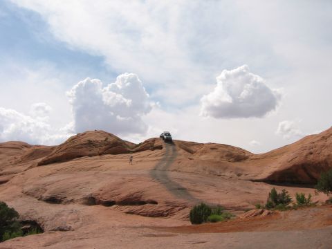 1997 Ford Ranger - A vehicle navigates a steep, dusty trail in a desert environment under a cloudy sky.