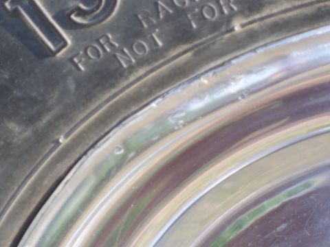 1967 Volkswagen Beetle - A tire and chrome wheel are shown in close-up, with visible text on the tire.