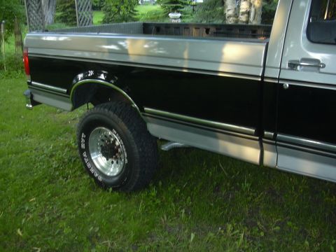 1992 Ford F-250 - Side view of a two-tone 1992 Ford F-250 pickup truck parked on grass.