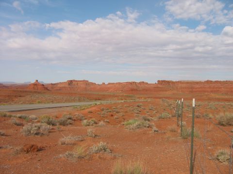 1997 Ford Ranger - A vast desert landscape unfolds with towering red rock formations under a partly cloudy sky.