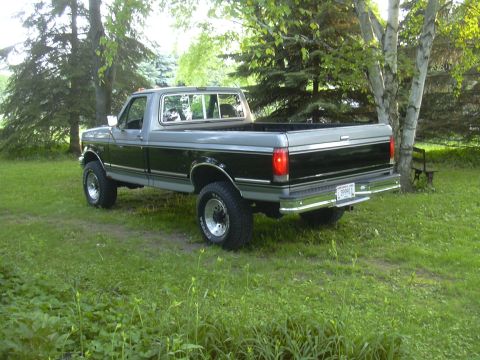1992 Ford F-250 - Rear view of a two-tone 1992 Ford F-250 pickup truck in a natural setting.