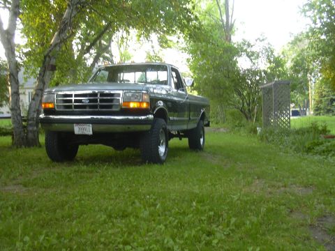 1992 Ford F-250 - 1992 Ford F-250 pickup truck parked in a grassy yard.