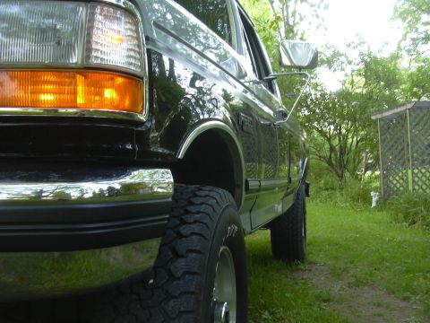 1992 Ford F-250 - This black Ford F-250 pickup truck is shown from the front quarter angle, parked outdoors.