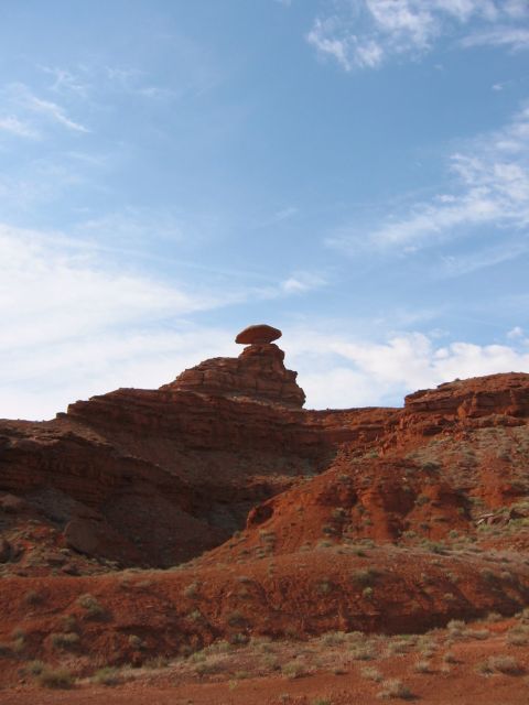 1997 Ford Ranger - Desert landscape with a unique balanced rock formation against a backdrop of red rock hills and blue sky.