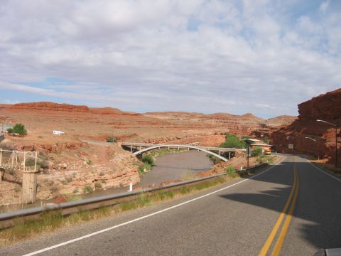 1997 Ford Ranger - Scenic view of a desert landscape with a river and bridges under a cloudy sky.