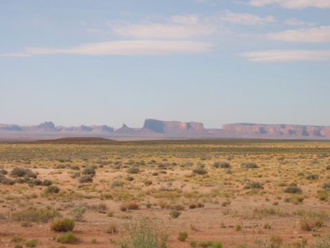 1997 Ford Ranger - A wide desert vista with distant mesas under a hazy sky, a "SUPERMOTORS" watermark.