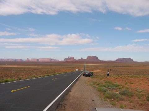 1997 Ford Ranger - Scenic view of Monument Valley with a road and vehicles on the side.