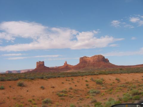 1997 Ford Ranger - A scenic view of Monument Valley's iconic buttes and mesas under a vast blue sky with scattered clouds.