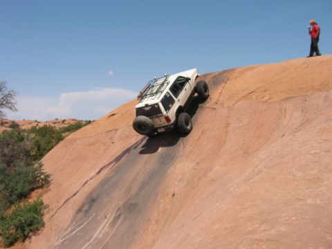 1997 Ford Ranger - A white 1997 Ford Ranger navigates a challenging rock climb in a desert landscape.