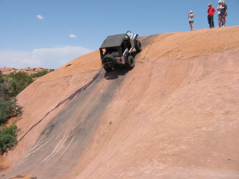 1997 Ford Ranger - An off-road vehicle navigates a challenging ascent on a rocky desert landscape.