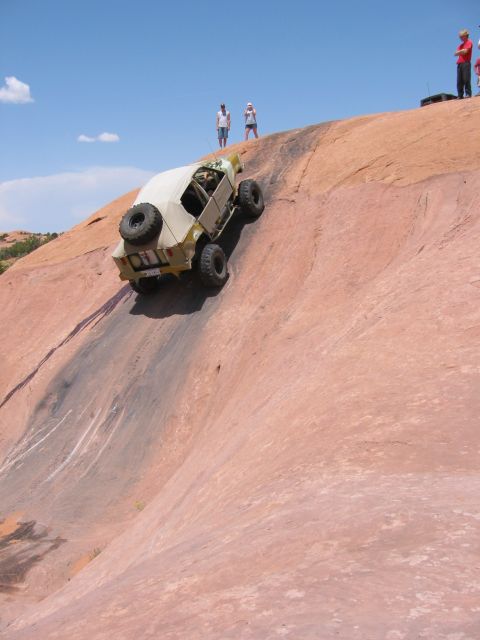1997 Ford Ranger - Off-road vehicle navigates a challenging rock climb in a desert landscape.