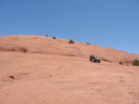 1997 Ford Ranger - Multiple off-road vehicles navigate a steep, rocky incline on a sunny day.