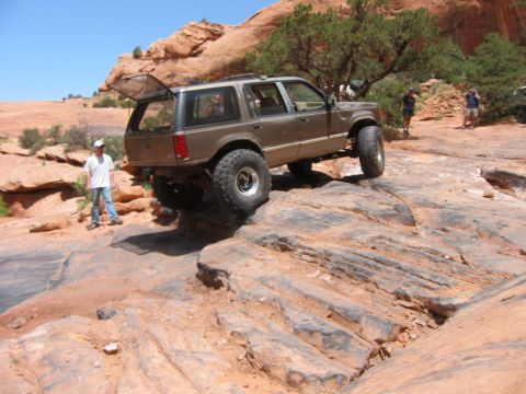 1997 Ford Ranger - This modified Ford Explorer is navigating a challenging rocky terrain on an off-road adventure.