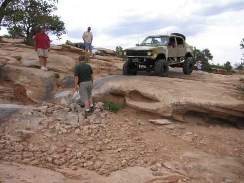 1997 Ford Ranger - A heavily modified truck navigates a rocky trail with onlookers present.