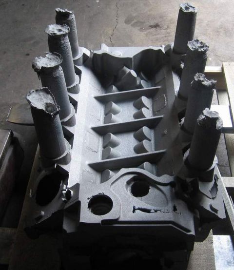 1972 Ford Ranchero - Bare V8 engine block sitting upside down on a pallet after media blasting, with all eight cylinder-bore sleeves protruding and the main bea…