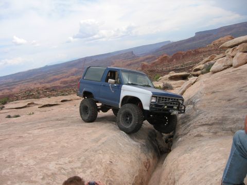 1997 Ford Ranger - Modified Ford Bronco tackling a challenging off-road course in a desert landscape.