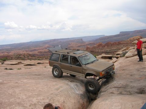 1997 Ford Ranger - A modified 1995 Ford Explorer navigates a rocky trail with its front right tire precariously positioned.