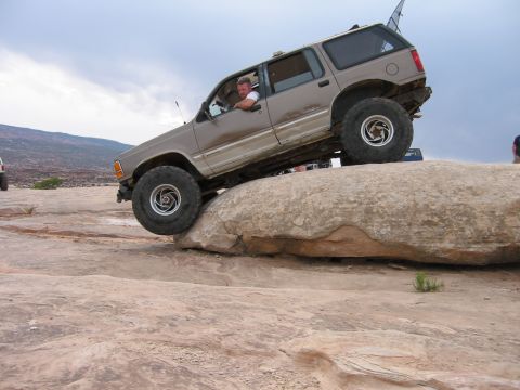 1997 Ford Ranger - Ford Explorer navigating a difficult rock obstacle during an off-road excursion.
