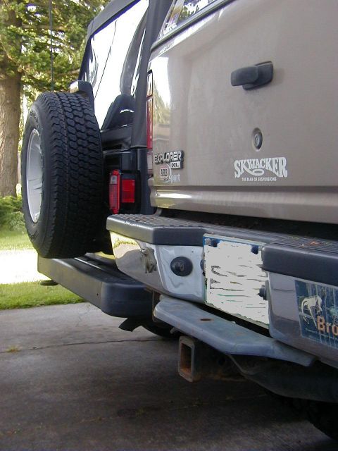 1994 Ford Explorer - Rear view of a tan 1995 Ford Explorer showing the bumper and spare tire.