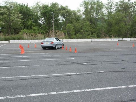 2001 Mercury Grand Marquis - Silver sedan maneuvers through an autocross course marked by orange cones.