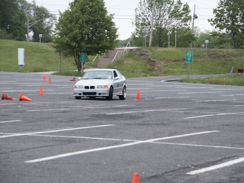 2001 Mercury Grand Marquis - Silver sedan with front-mounted grille and headlights, parked on asphalt with orange cones.