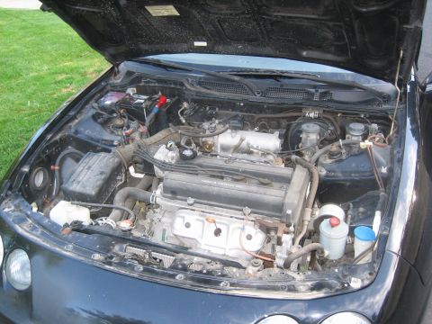 1995 Ford Bronco - The engine bay of a black vehicle, a VTEC engine. A Supermotors.net logo is visible in the lower right corner.