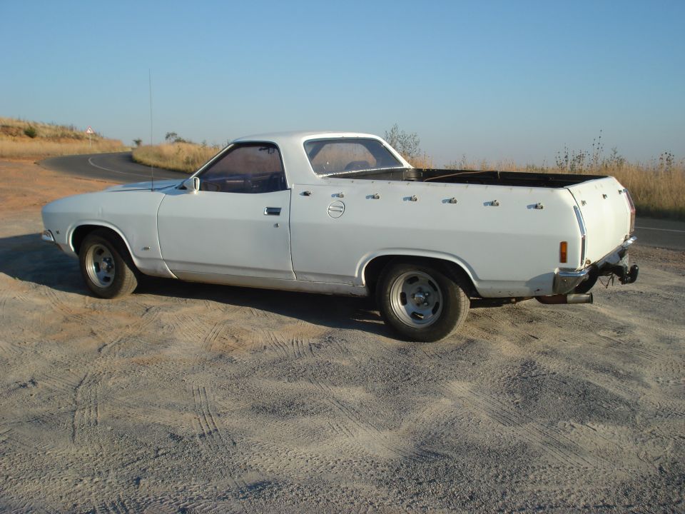 1976 Ford Ranchero parked on dirt road, side view