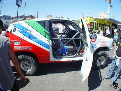 1992 Ford Explorer - This modified SUV is equipped for off-road racing with a prominent roll cage and racing livery.