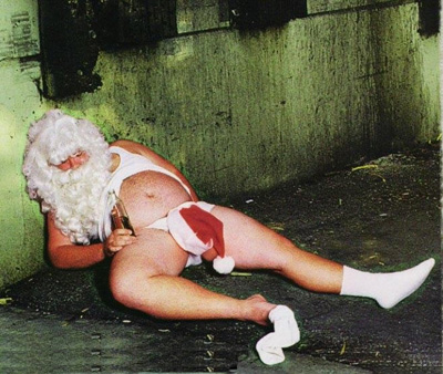 1991 Ford Bronco - A man dressed as Santa Claus is seen lying on the ground, appearing intoxicated.