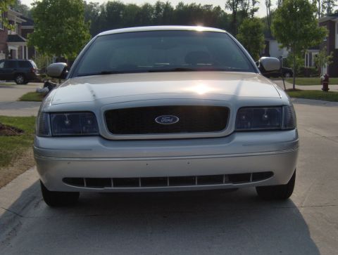 2002 Ford Crown Victoria - Front view of a silver 2002 Ford Crown Victoria parked in a driveway.