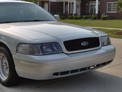 2002 Ford Crown Victoria - Front view of a silver 2002 Ford Crown Victoria showing the grille and headlights.