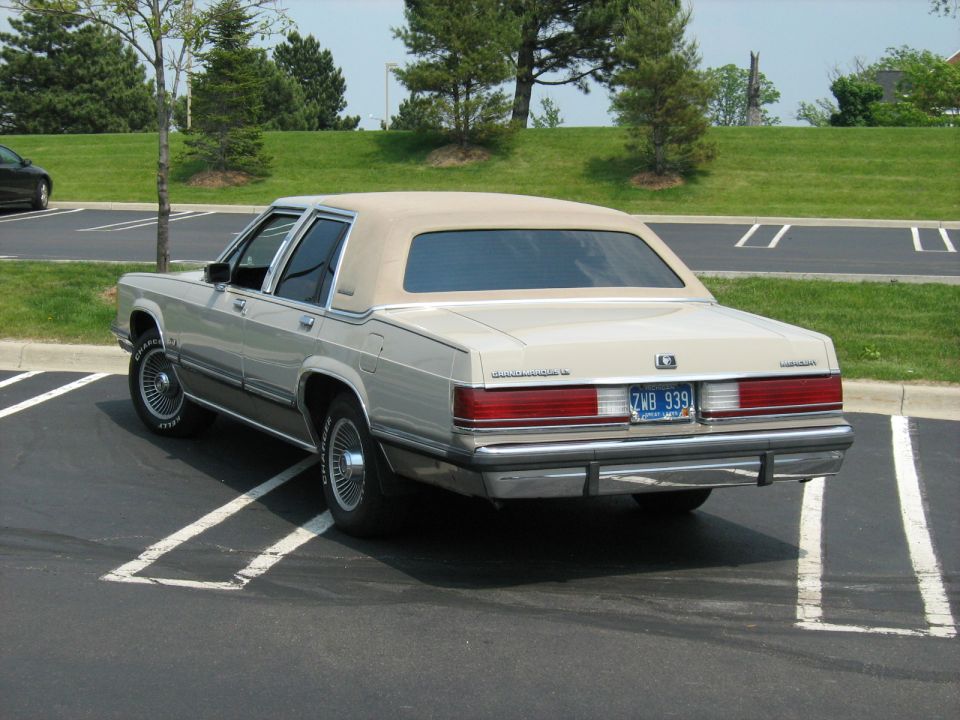 Rear three-quarter of a tan Mercury Grand Marquis sedan in parking lot