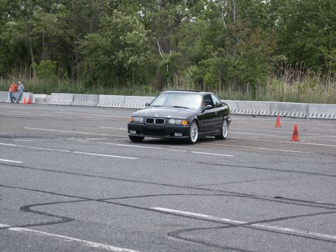 2001 Mercury Grand Marquis - Black BMW E36 coupe on a track during an event.