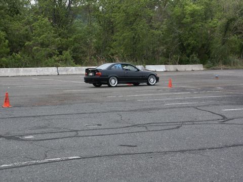 2001 Mercury Grand Marquis - A black coupe with racing number 79 navigates an autocross course marked by orange cones.