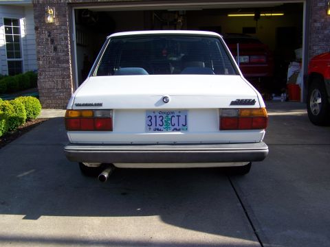 1984 Volkswagen Jetta - Rear view of a 1984 Volkswagen Jetta parked in a driveway, with another vehicle inside a garage.