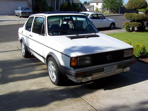 1984 Volkswagen Jetta - White 1984 Volkswagen Jetta sedan with a sunroof, parked in a driveway with another car behind it.