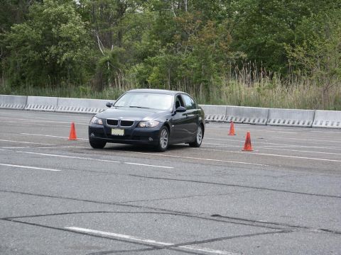 2001 Mercury Grand Marquis - BMW 3 Series sedan driving through an autocross course marked by orange cones.