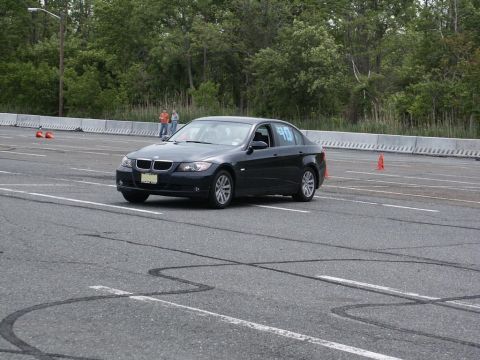 2001 Mercury Grand Marquis - A dark sedan navigates a course marked by cones on a paved track.