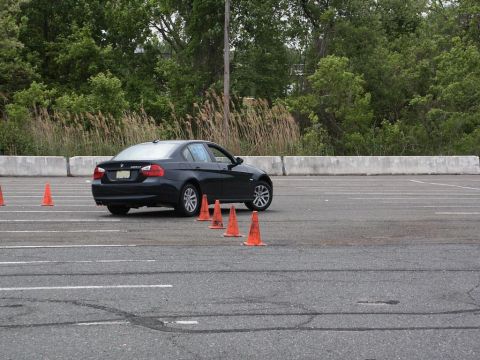 2001 Mercury Grand Marquis - Dark sedan navigates an autocross course marked by orange cones.