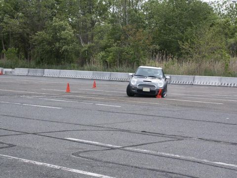 2001 Mercury Grand Marquis - A silver Mini Cooper S navigates an autocross course with orange cones on the asphalt.