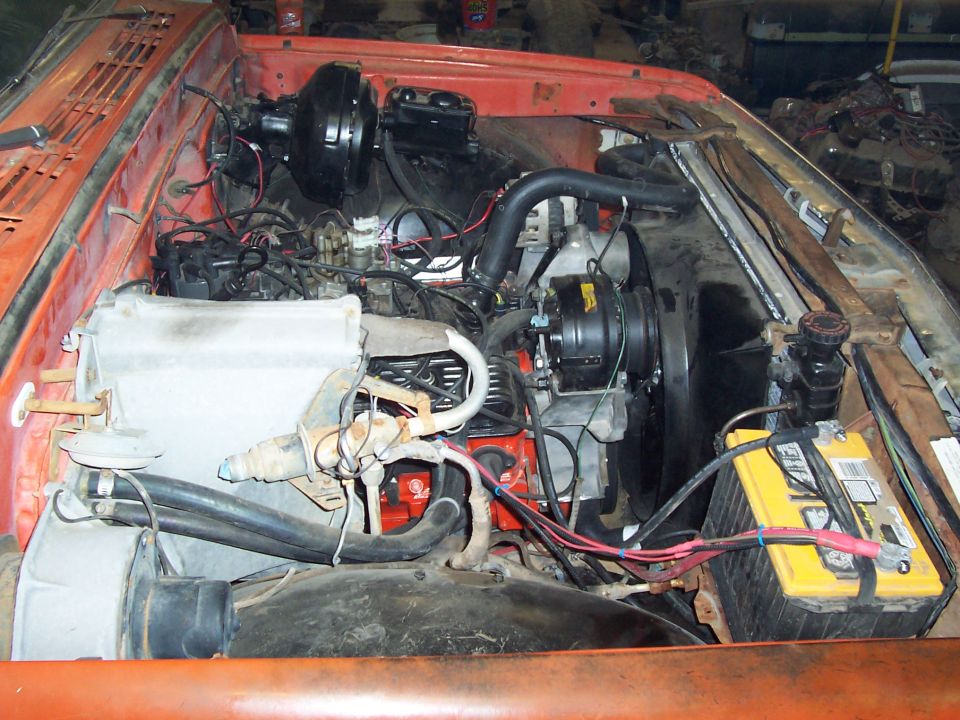 1972 Chevrolet C/K Pickup engine bay with orange paint and visible V8 engine