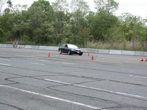 2001 Mercury Grand Marquis - A black sedan drives through an autocross course marked by orange cones.