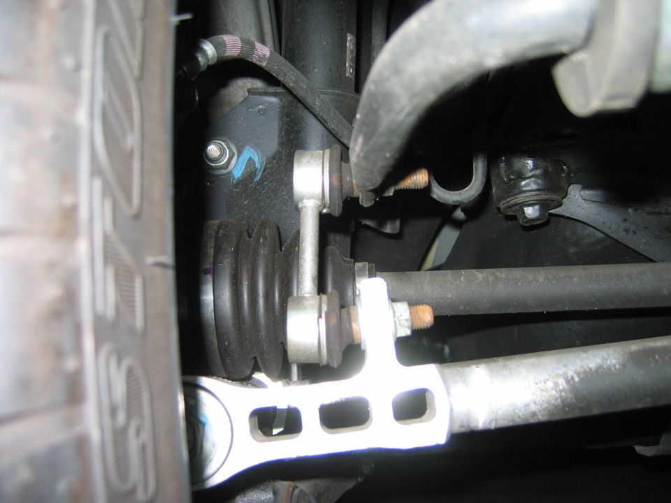 Underside view of front suspension sway bar end link and CV boot